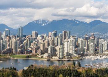 Stunning view of Vancouver's skyline with mountains and marina in the background.